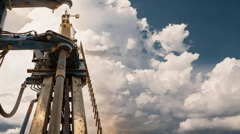 Close view of a drilling rig on an industrial work site, mast and drive machinery