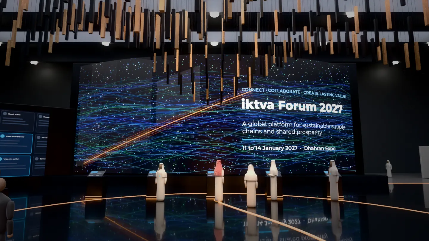Curved 24 metre main LED wall reading iktva Forum 2027 with synchronised touch podiums in front and a kinetic copper installation above