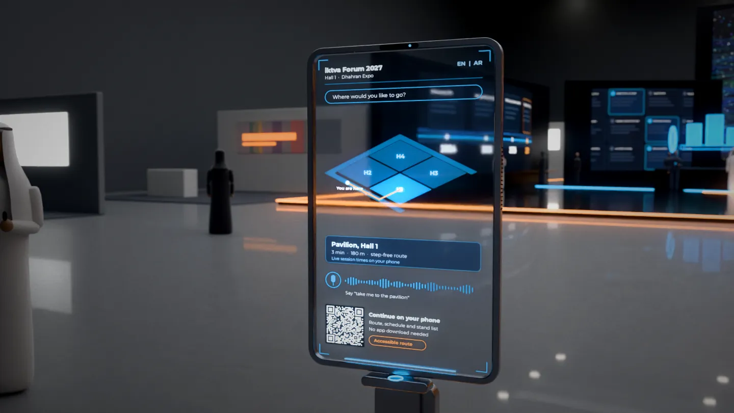 Transparent touch wayfinder totem at the pavilion entrance in Hall 1 at Dhahran Expo, showing a hall map, a copper route line, voice prompt and a QR code over a clear screen